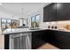 Modern kitchen with island, stainless steel appliances, and dark cabinetry at 808 Culpepper Ln, Raleigh, NC 27610