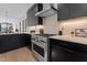Modern kitchen with stainless steel appliances and dark cabinetry at 808 Culpepper Ln, Raleigh, NC 27610