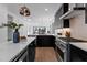 Modern kitchen with stainless steel appliances and dark cabinetry at 808 Culpepper Ln, Raleigh, NC 27610