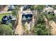 Aerial view of the house with a black roof and white walls, surrounded by lush greenery at 85 Arbor Dr, Youngsville, NC 27596