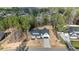 Aerial view of a home, featuring a driveway and surrounded by lush trees in a neighborhood at 85 Arbor Dr, Youngsville, NC 27596
