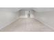 Large unfinished attic space ready for customization, with exposed beams and a door on the left at 85 Arbor Dr, Youngsville, NC 27596