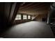 Unfinished attic space with three windows and exposed rafters at 85 Arbor Dr, Youngsville, NC 27596