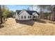 Back of the house with a wooden porch and spacious yard, with lush landscaping surrounding the property at 85 Arbor Dr, Youngsville, NC 27596