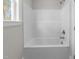 Clean, white tub and shower combination unit with easy-to-reach controls and a clear window view at 85 Arbor Dr, Youngsville, NC 27596