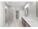 Bright bathroom with double vanity, tile floors and a glass-enclosed shower at 85 Arbor Dr, Youngsville, NC 27596