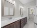 Bathroom featuring double sink vanity with sleek cabinetry and two framed mirrors at 85 Arbor Dr, Youngsville, NC 27596