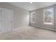 Spacious bedroom featuring plush carpeting and an abundance of natural light from dual windows at 85 Arbor Dr, Youngsville, NC 27596