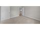 Carpeted bedroom featuring neutral walls, white trim and two doors at 85 Arbor Dr, Youngsville, NC 27596