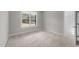 Carpeted bedroom featuring neutral walls and natural light at 85 Arbor Dr, Youngsville, NC 27596