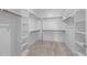 Walk-in closet with multiple levels of shelving and carpeted floor at 85 Arbor Dr, Youngsville, NC 27596