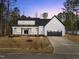 Charming two-story farmhouse with black and white accents and a spacious two-car garage at 85 Arbor Dr, Youngsville, NC 27596