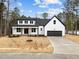 Charming two-story farmhouse with black and white accents and a spacious two-car garage at 85 Arbor Dr, Youngsville, NC 27596