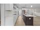 Bright kitchen featuring stainless steel appliances, white cabinetry, a kitchen island, and hardwood floors at 85 Arbor Dr, Youngsville, NC 27596