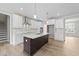 Bright kitchen featuring stainless steel appliances, white cabinetry, a kitchen island, and hardwood floors at 85 Arbor Dr, Youngsville, NC 27596