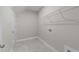 Functional laundry room with tile flooring, shelf, and washer/dryer hookups for convenience at 85 Arbor Dr, Youngsville, NC 27596