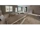 Spacious living room with large windows, under construction with drywall and debris at 85 Arbor Dr, Youngsville, NC 27596