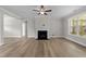 Bright living room featuring a fireplace, ceiling fan and wood-look flooring at 85 Arbor Dr, Youngsville, NC 27596
