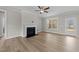 Spacious living room with fireplace, ceiling fan and door to outdoor porch at 85 Arbor Dr, Youngsville, NC 27596