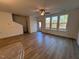 Open living room with wood-look floors and lots of natural light at 8946 Kennebec Crossing Dr # 79, Angier, NC 27501