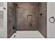 Updated bathroom with dark tile shower and new bathtub at 905 Corona St, Durham, NC 27707