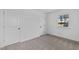Well-lit bedroom featuring neutral walls, carpet, and two closets at 905 Corona St, Durham, NC 27707