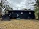 Black exterior house with steps leading to a small deck at 905 Corona St, Durham, NC 27707