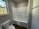 Clean bathroom with a tub/shower combo and wood-look flooring at 93 Faucette Dr, Selma, NC 27576