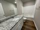 Bathroom with shower/tub combo, granite countertop, and white cabinets at 93 Faucette Dr, Selma, NC 27576