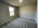 Simple bedroom with window and neutral wall color at 93 Faucette Dr, Selma, NC 27576