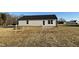 Back exterior of house with small patio and yard at 93 Faucette Dr, Selma, NC 27576