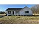 Charming one-story house with vinyl siding, a gray roof, and a small front yard at 93 Faucette Dr, Selma, NC 27576