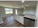 Modern kitchen with granite countertops, white cabinets, and stainless steel dishwasher at 93 Faucette Dr, Selma, NC 27576