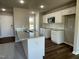 Modern kitchen with white cabinets, granite countertops, and a breakfast bar at 93 Faucette Dr, Selma, NC 27576