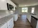 Open concept kitchen with granite countertops, white cabinets, and stainless steel appliances at 93 Faucette Dr, Selma, NC 27576