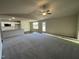 Spacious living room with high ceilings, ceiling fan, and neutral-toned carpet at 93 Faucette Dr, Selma, NC 27576