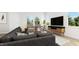 Cozy living room featuring a sectional sofa and large flat-screen TV at 935 Selby Ave, Durham, NC 27713