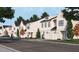 Street view featuring townhomes with black roofs, white siding, and front-entry garages at 935 Selby Ave, Durham, NC 27713