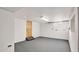 Clean, finished basement with neutral walls and gray flooring at 103 W Delafield Ave, Durham, NC 27704