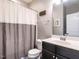 Bathroom with shower/tub combo, toilet and dark vanity at 121 Belleforte Park Cir, Garner, NC 27529