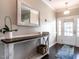 Bright and spacious entryway with a wooden console table and mirror at 121 Belleforte Park Cir, Garner, NC 27529