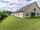 Expansive backyard space with a covered patio, offering a serene view of the property and neighboring homes at 13 Needham Ln, Clayton, NC 27527