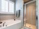 Bathroom with shower, tub, and updated fixtures at 13 Needham Ln, Clayton, NC 27527