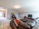 Spacious bonus room with leather sectional sofa and recliner at 13 Needham Ln, Clayton, NC 27527