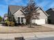 This beautiful home boasts a large front yard, neutral siding, and a two-car garage at 13 Needham Ln, Clayton, NC 27527