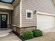 Close up of the exterior of the home, featuring a front door, siding, stone accents and two-car garage at 13 Needham Ln, Clayton, NC 27527