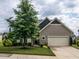 Charming single-Gathering home with a two-car garage and a beautifully landscaped front yard and mature tree at 13 Needham Ln, Clayton, NC 27527