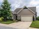 Charming single-Gathering home featuring a two-car garage, neutral siding, and landscaped front yard at 13 Needham Ln, Clayton, NC 27527