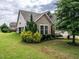 Well-maintained backyard and side exterior view showcasing a patio and plenty of outdoor space at 13 Needham Ln, Clayton, NC 27527