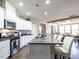 Open concept kitchen with white cabinets, granite island, and stainless steel appliances at 13 Needham Ln, Clayton, NC 27527